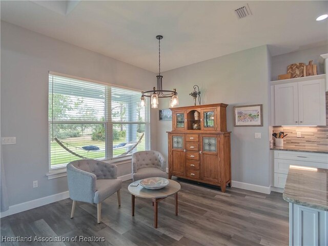 4936 Myrtle Dr, Sebring, FL 33872 - living area with dark wood-style flooring and a chandelier