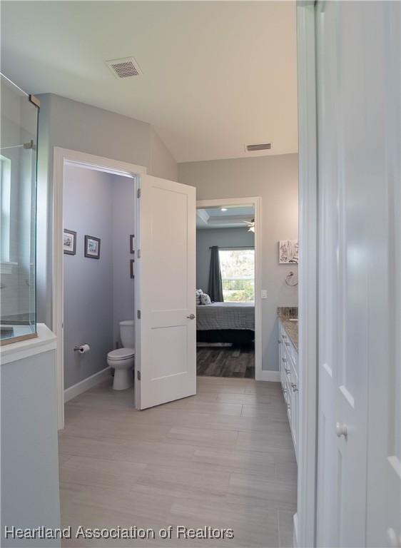 4936 Myrtle Dr, Sebring, FL 33872 - ensuite bathroom featuring wood finished floors and vanity