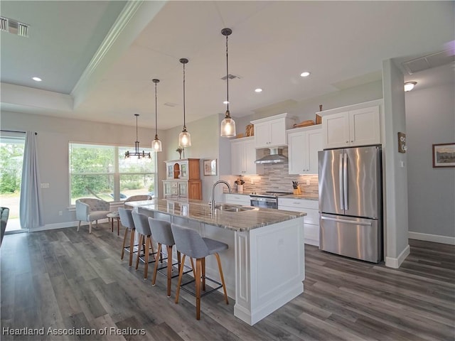 4936 Myrtle Dr, Sebring, FL 33872 - kitchen featuring stainless steel appliances, exhaust hood, dark wood-style flooring, white cabinets, and recessed lighting