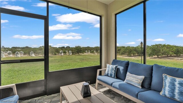 sunroom / solarium with a healthy amount of sunlight and a rural view