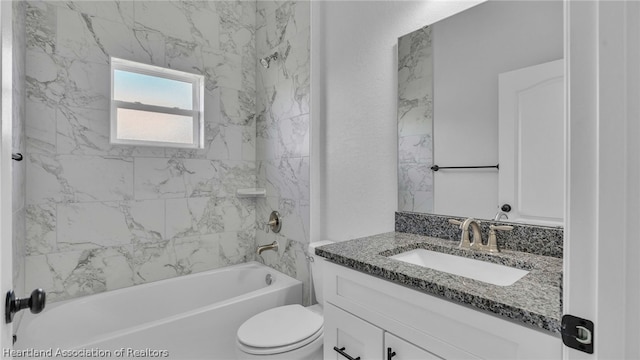 full bathroom featuring vanity, tiled shower / bath combo, and toilet