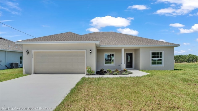 view of front of home with a front lawn, cooling unit, and a garage