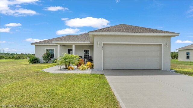 view of front of property with a garage and a front lawn