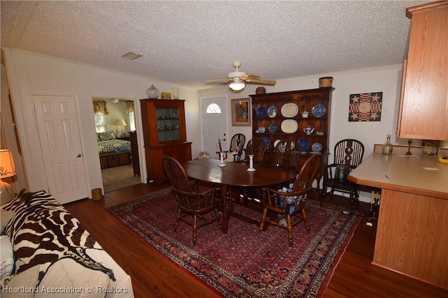 dining space with lofted ceiling, ceiling fan, dark hardwood / wood-style flooring, and a textured ceiling