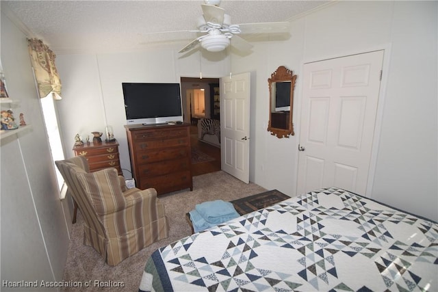 bedroom with a textured ceiling, ceiling fan, and light carpet
