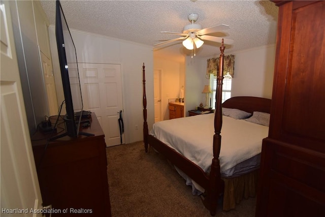 carpeted bedroom featuring ceiling fan, ornamental molding, a textured ceiling, and ensuite bath