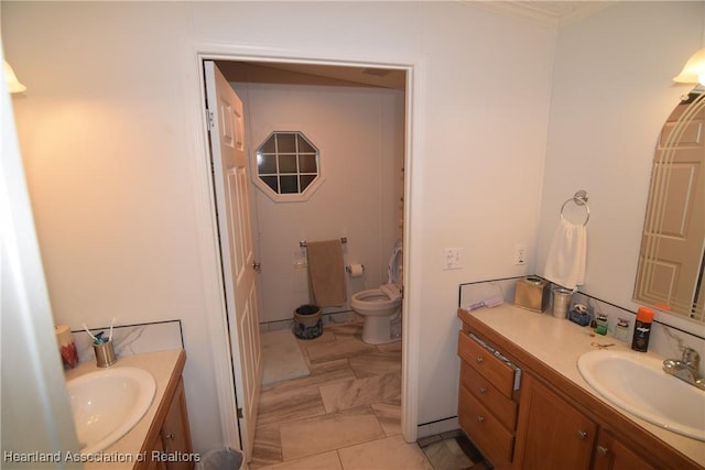 bathroom with tile patterned flooring, vanity, and toilet