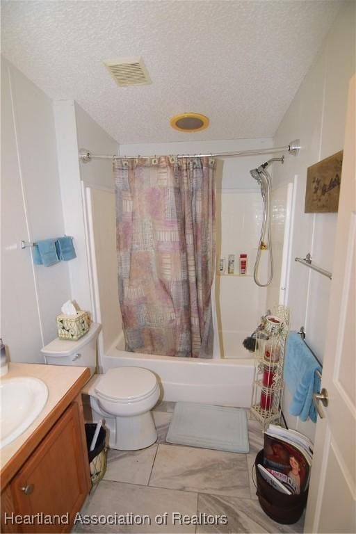 full bathroom with vanity, shower / bath combo, a textured ceiling, and toilet