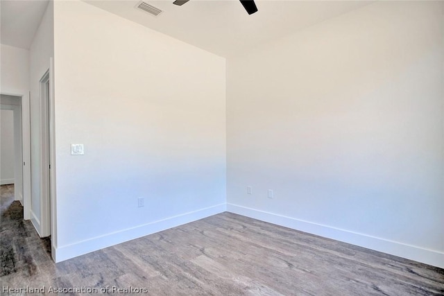 spare room with hardwood / wood-style flooring and ceiling fan