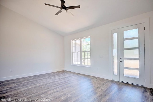 foyer entrance featuring vaulted ceiling, ceiling fan, and dark wood-type flooring