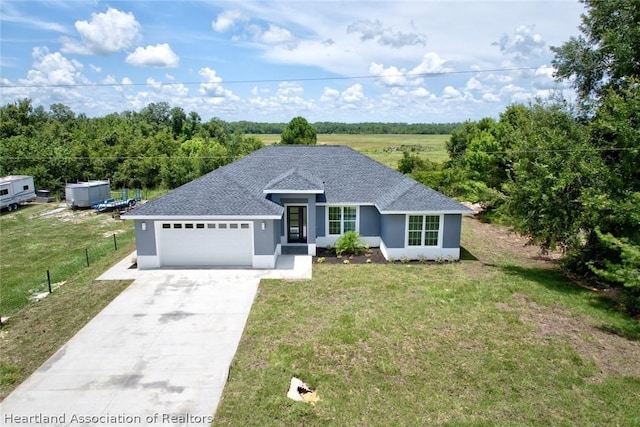 ranch-style house with a garage and a front lawn