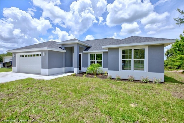 view of front facade featuring a garage and a front lawn