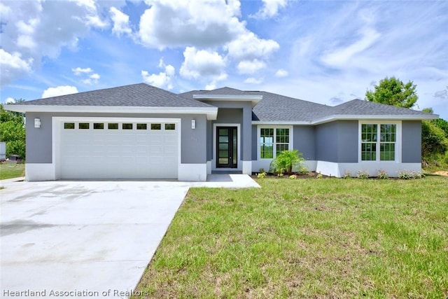 view of front of house with a front yard and a garage