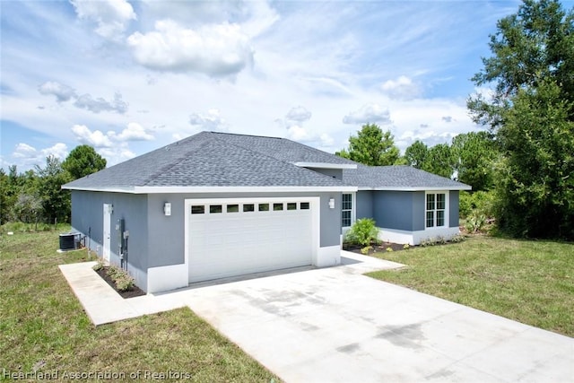 view of front facade with cooling unit, a garage, and a front lawn