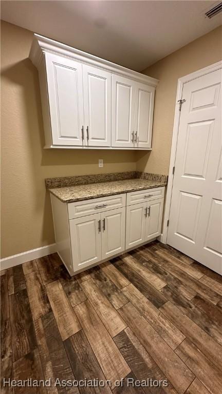 washroom with dark wood-type flooring