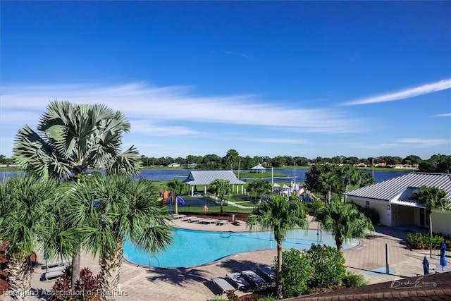 view of pool featuring a patio area and a water view