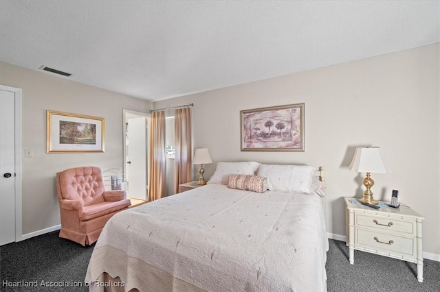 carpeted bedroom featuring a textured ceiling