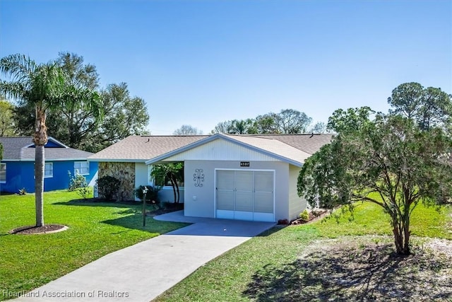 single story home featuring a garage and a front yard