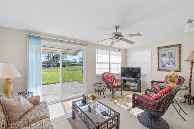 living room featuring light tile patterned floors and ceiling fan