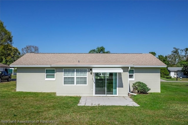 rear view of house with a yard and a patio area