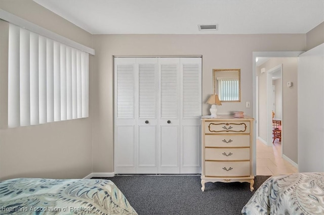 carpeted bedroom featuring a closet