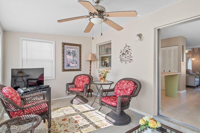 sitting room with light tile patterned floors and ceiling fan