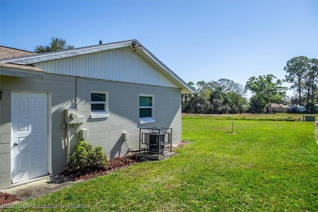 view of property exterior with a lawn and central air condition unit