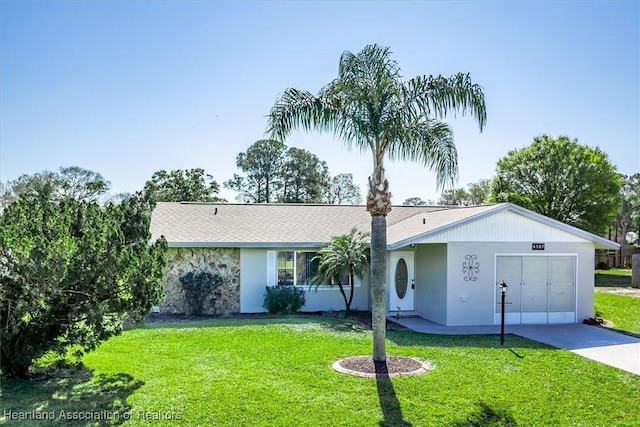 ranch-style house with a garage and a front lawn