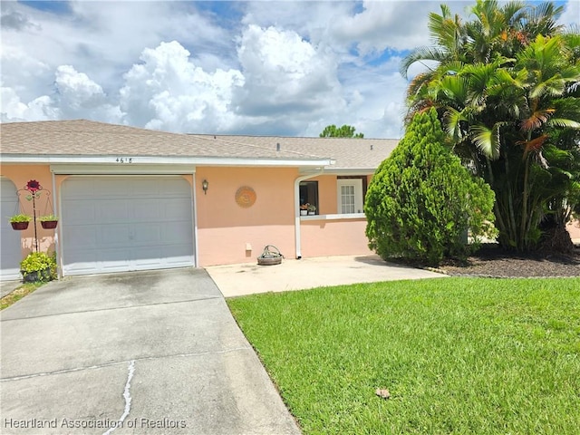 4618 Lafayette Ave, Sebring, FL 33875 - view of front of property with stucco siding, driveway, a front yard, and an attached garage