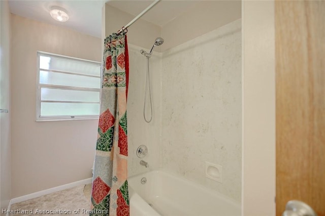 bathroom with shower / bath combo with shower curtain