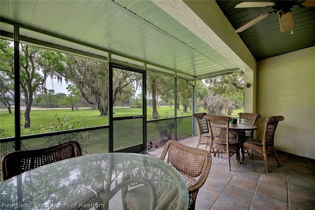 sunroom / solarium featuring ceiling fan and wood ceiling