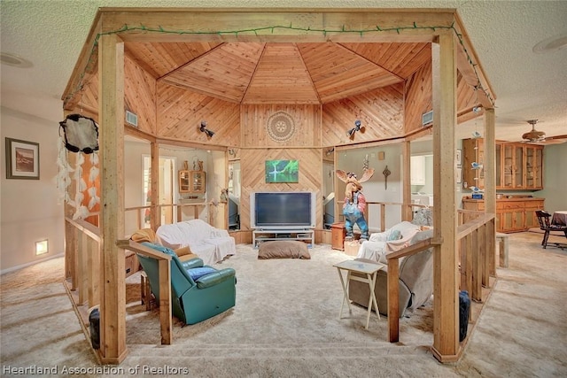 carpeted living room featuring high vaulted ceiling, wooden walls, wooden ceiling, and a textured ceiling