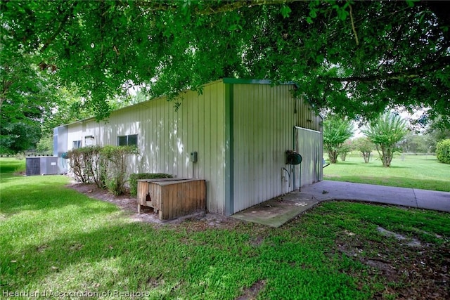 view of outbuilding with a yard