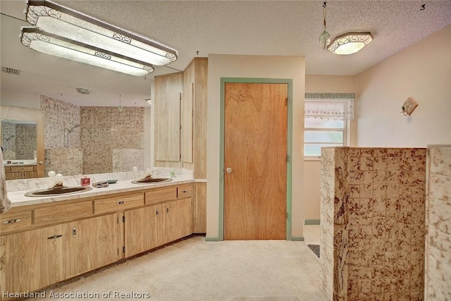 bathroom featuring vanity, a textured ceiling, and walk in shower