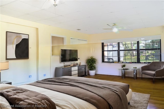 bedroom with dark wood-type flooring