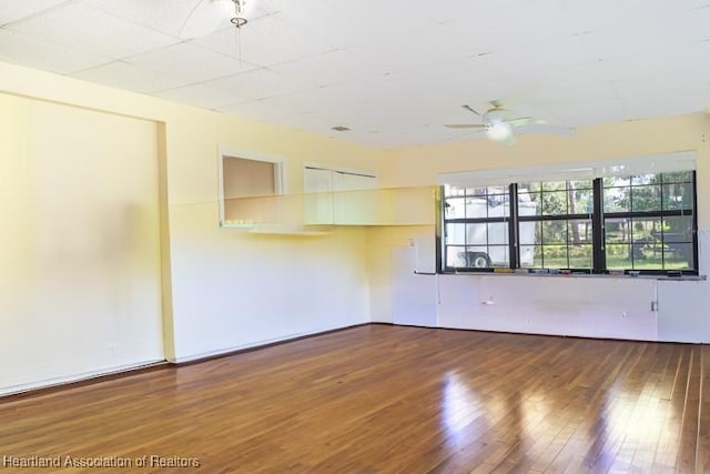 spare room with hardwood / wood-style flooring and ceiling fan