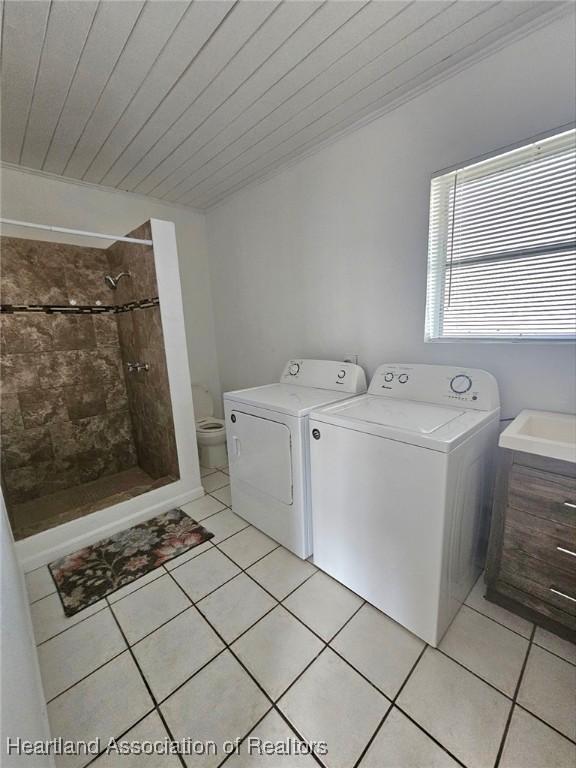908 Taseschee Dr, Sebring, FL 33870 - laundry room with washing machine and dryer, light tile patterned flooring, and wooden ceiling