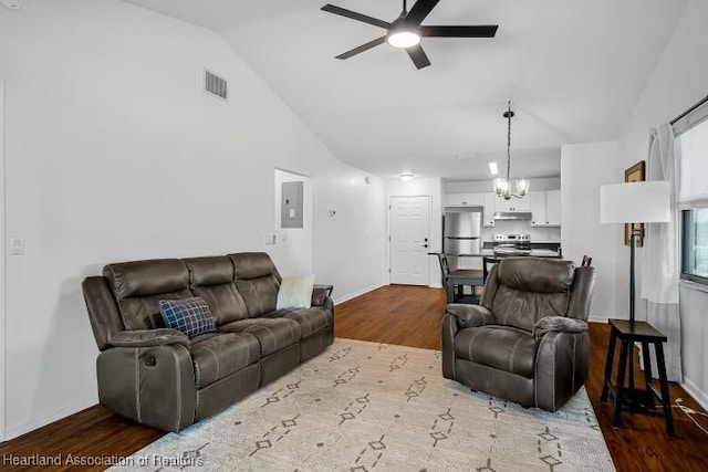 living area with electric panel, dark wood-style floors, baseboards, visible vents, and ceiling fan with notable chandelier