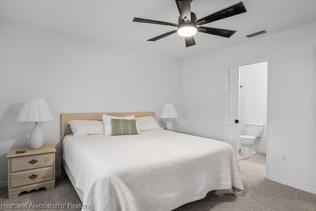 carpeted bedroom featuring connected bathroom, ceiling fan, baseboards, and visible vents