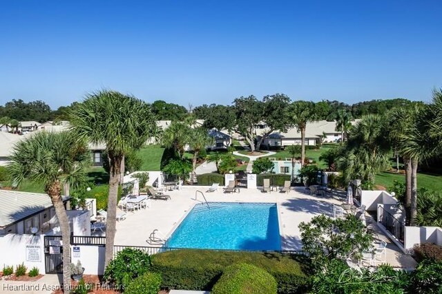 pool with fence and a patio area