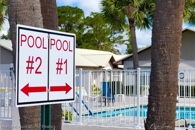 exterior space with a pool and fence