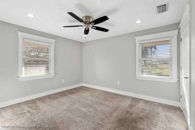 unfurnished room with ceiling fan, plenty of natural light, and carpet floors