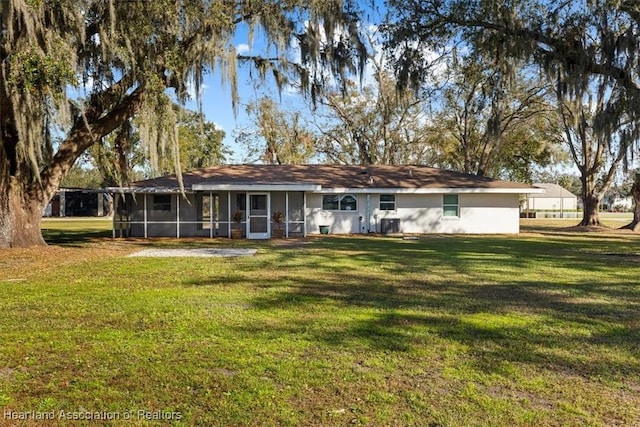 ranch-style home featuring a sunroom and a front lawn