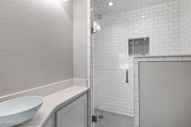 bathroom featuring an enclosed shower and vanity