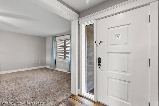 entryway featuring light colored carpet