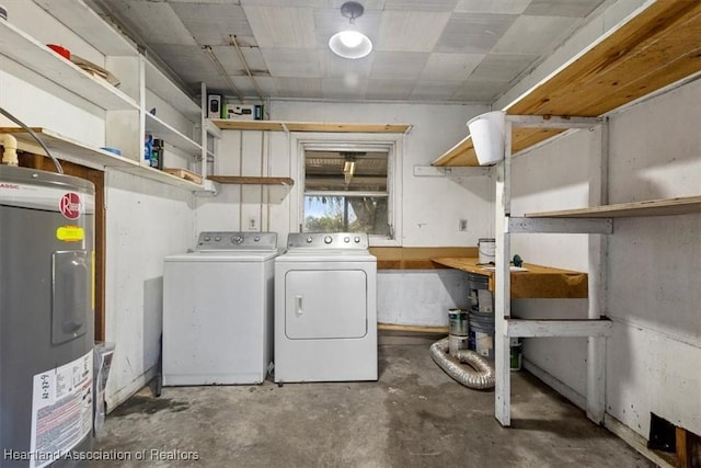 clothes washing area with water heater and separate washer and dryer