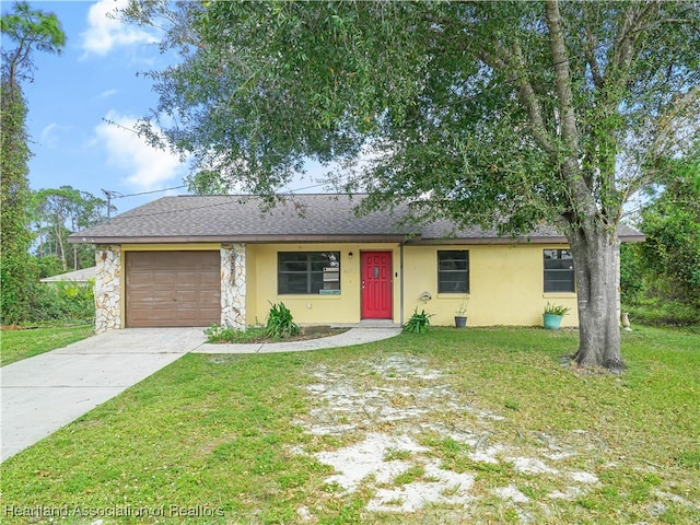 single story home featuring a garage and a front yard