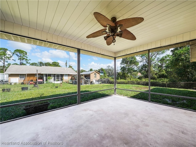 unfurnished sunroom with ceiling fan