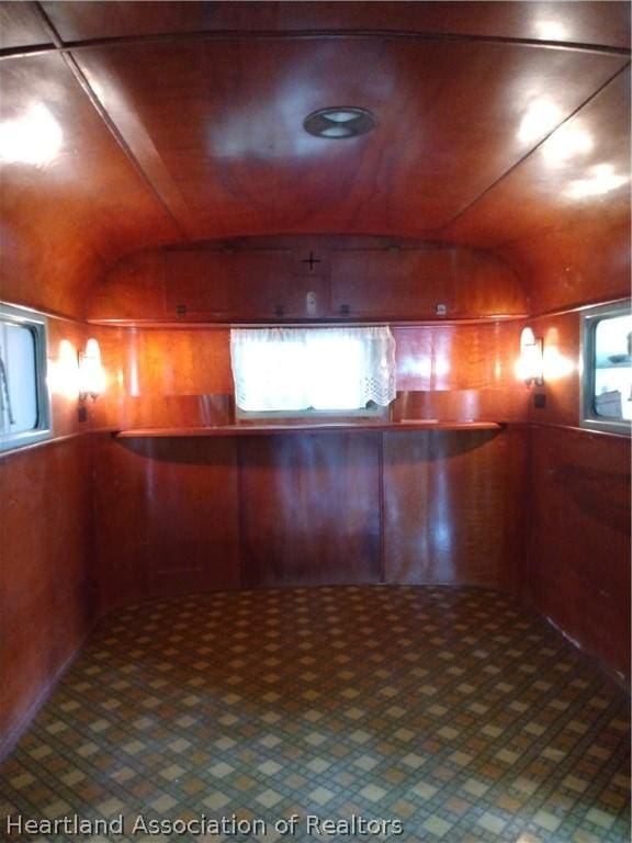 interior space with wooden ceiling and wood walls