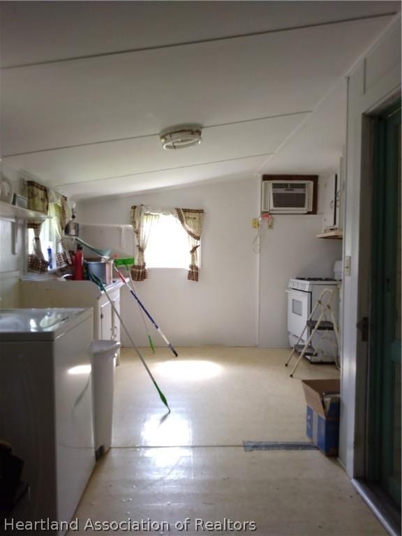 laundry area with independent washer and dryer and a wall unit AC
